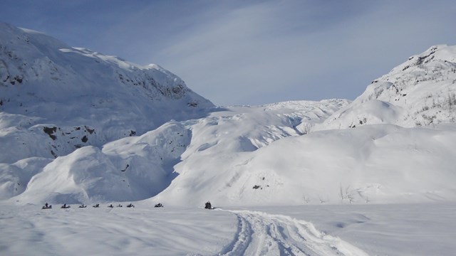 snowmobiles on the outwash plain near Exit Glacier