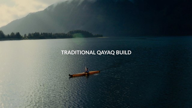 Title on screen "Traditional Qayaq Build" over a skin-on-frame qayaq (kayak) paddled on dark waters
