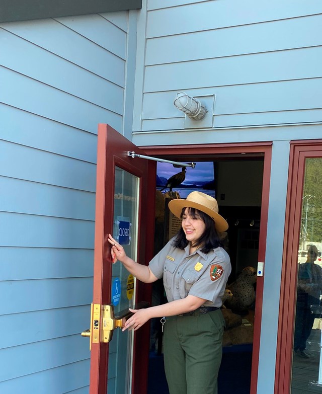 A park ranger waves in front of the Exit Glacier Nature Center. 