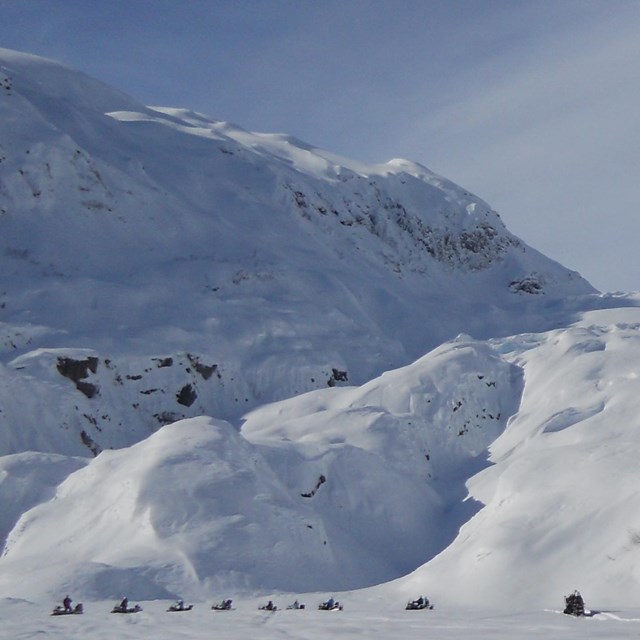 snowmobiles on the outwash plain near Exit Glacier