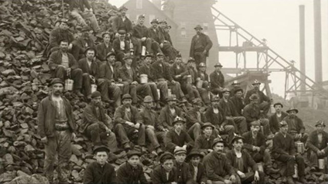 Historic photo of miners on rock pile