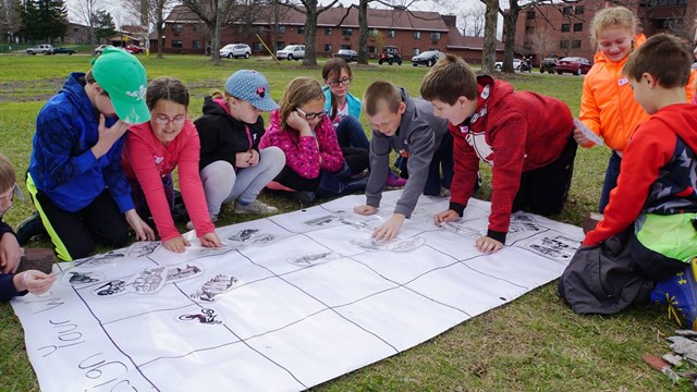 A group of students work on planning a community together.