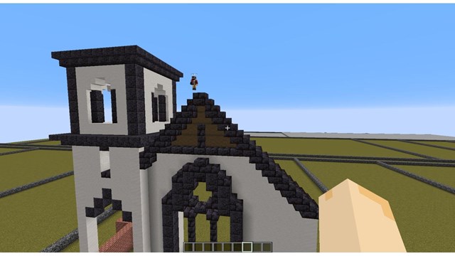 Minecraft player working on recreating the Norwegian Lutheran Church in downtown Calumet