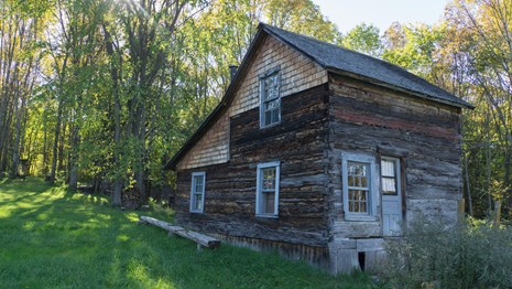 An older wood dwelling next to the forest.