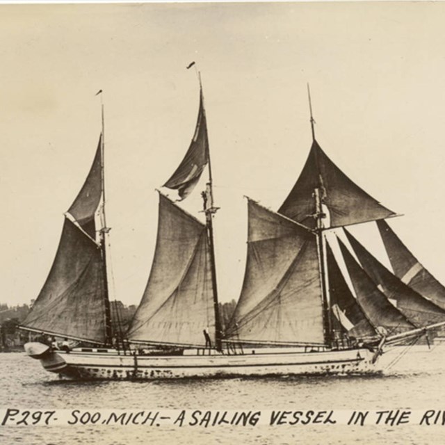 Schooner sailing in a river.