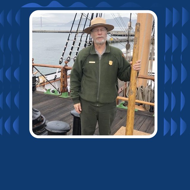 Park ranger stands on a historic tall ship 