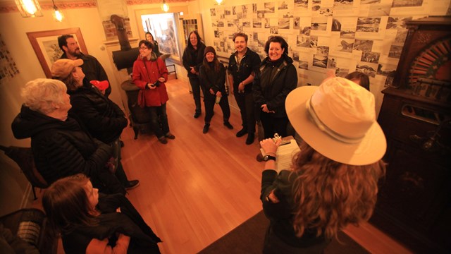 A ranger talks to people in a museum