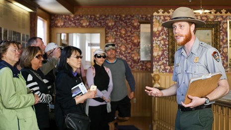 A ranger talks to a group of people