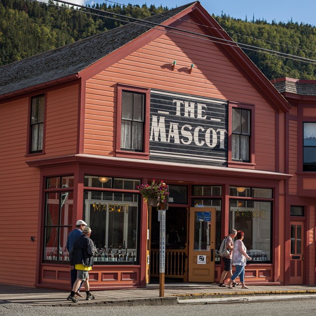 A brightly colored building with a large sign The Mascot