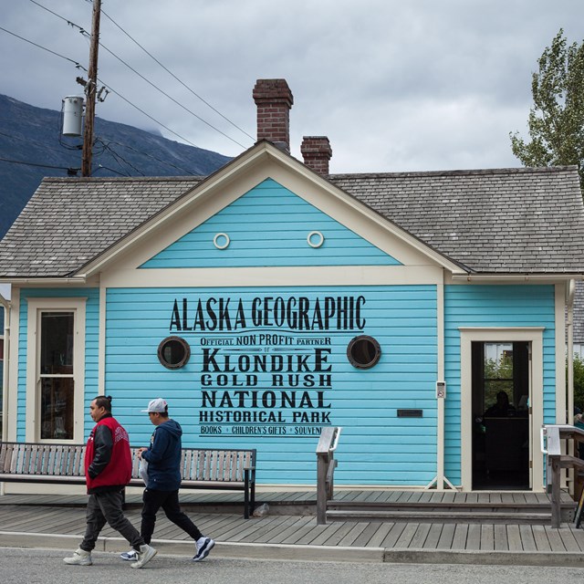 Bright blue building with portholes and a hand painted sign 