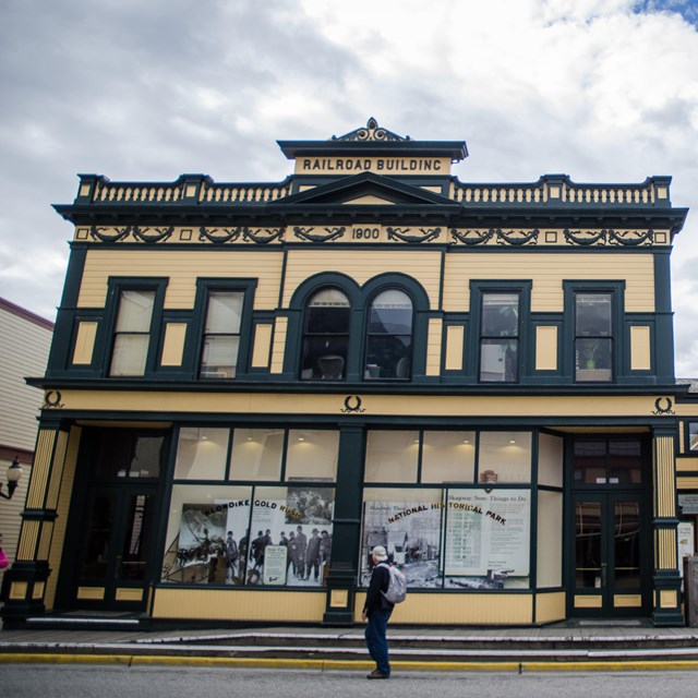 A yellow building with ornate dark green trim