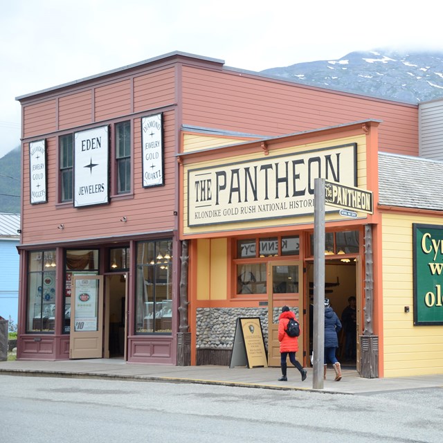 yellow building with a Pantheon sign and a two story red building