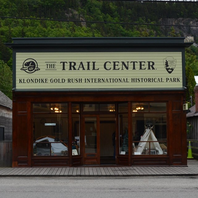 A building with a lustrous wood finish and sign Trail Center