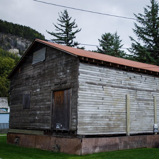 A weathered wooden building with metal roof