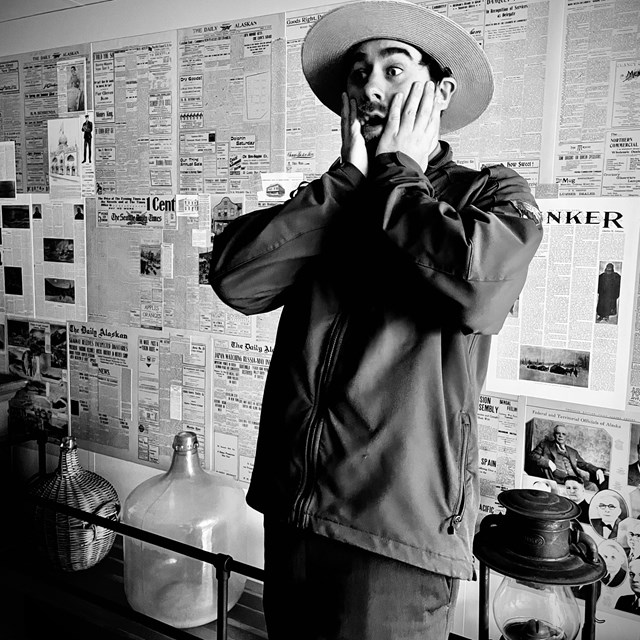 In a black and white photo and ranger looks shocked while his hands rest on the sides of his face. 