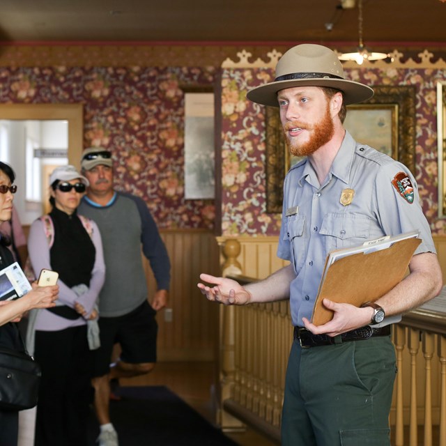 A ranger talks to a group of people