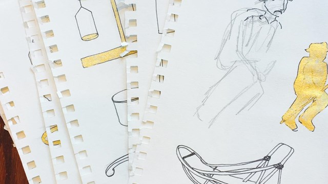 An image of sketches with gold components.
