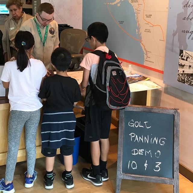 rangers talk to children at an information desk