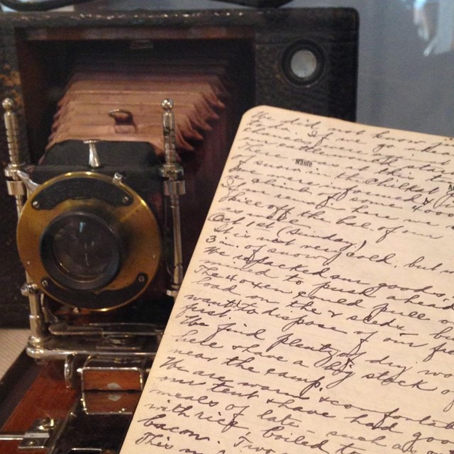 historic camera and hand written diary in display case