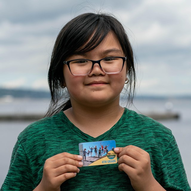 Agirl pose with a park pass