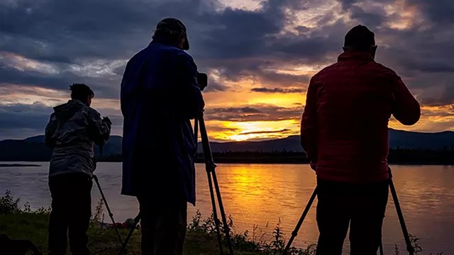 A group of photographers documenting a sunset 