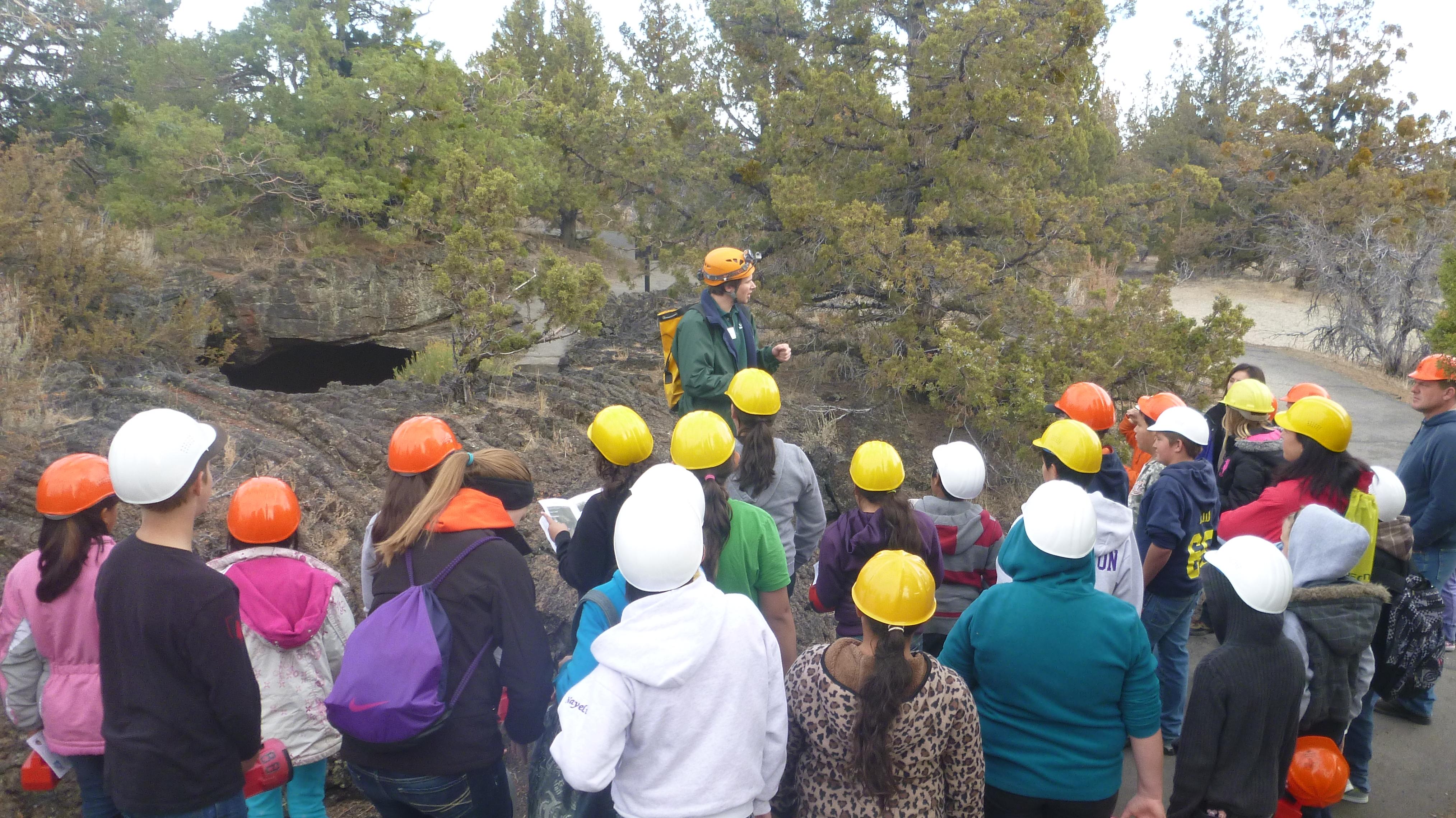 Ranger leading school group into a valentine cave 