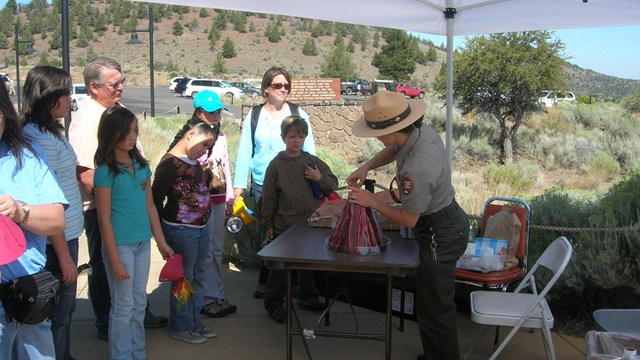 Ranger showing a volcano to children