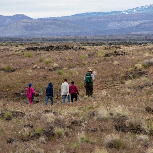 A ranger leading a group of school kids 