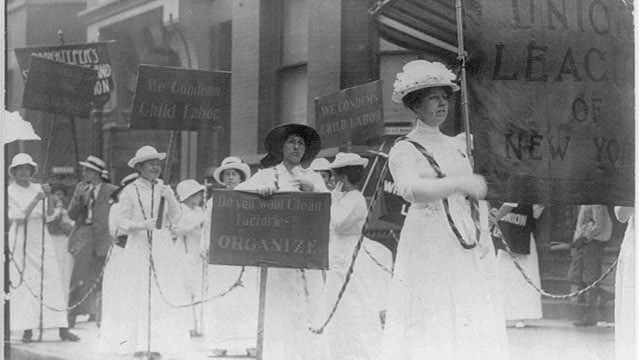 Female laundry workers march with banners calling for labor and voting rights