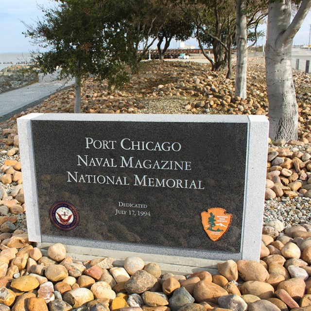 A sign near the shoreline reads Port Chicago Naval Magazine National Memorial