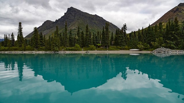 mountains and autumnal trees reflect in Twin Lakes