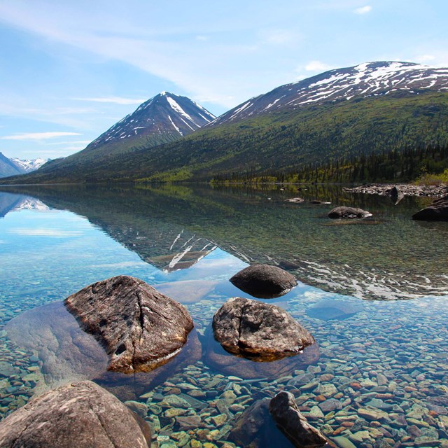 A clear lake shows the rocks below the surface