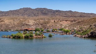 lake harbor with desert mountains and an island with vegetation