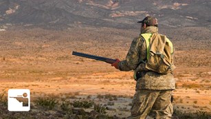 A hunter in camouflage in the desert