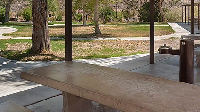 A picnic table inside a picnic shelter
