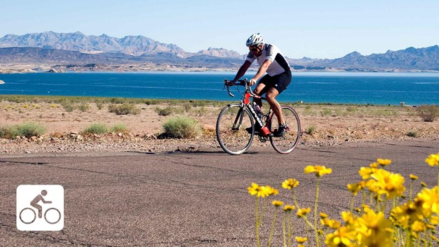 Person on a bike travelling near a lake