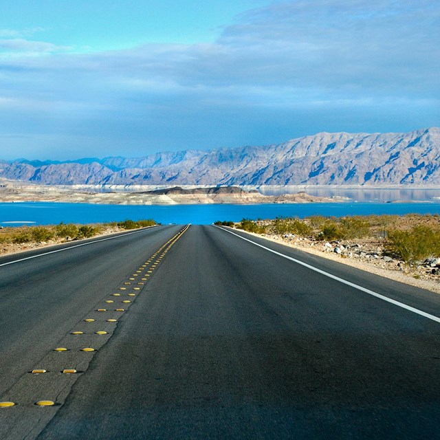 A road leads to a large, enclosed body of water