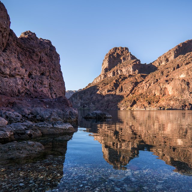 A river with mountains on both sides. 