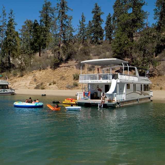 Several houseboats moored on the shoreline.