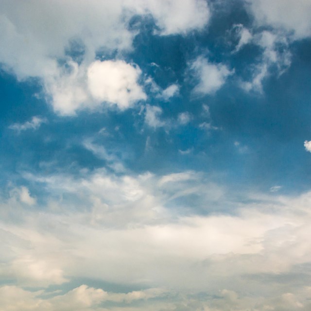 A partly cloudy day with bright blue skies.