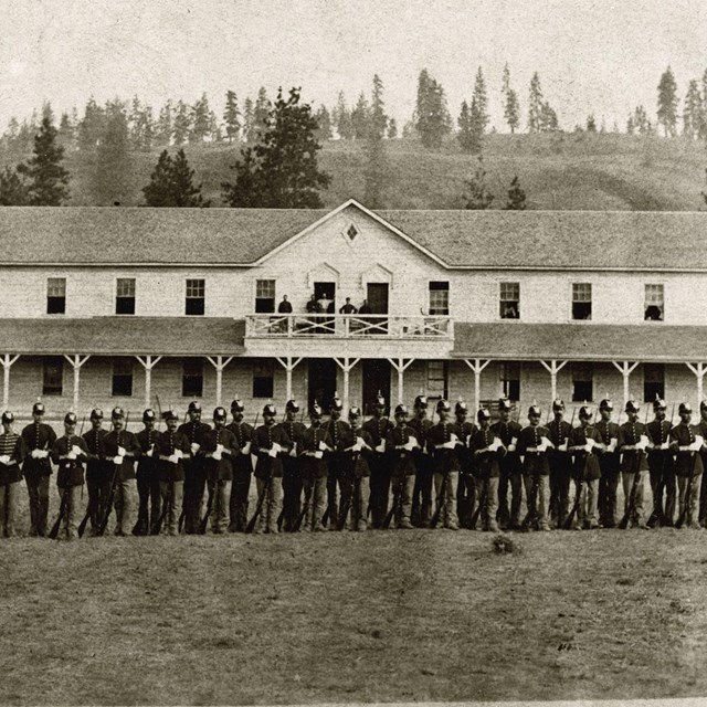 historic photos of soldiers standing in front of Fort Spokane guardhouse