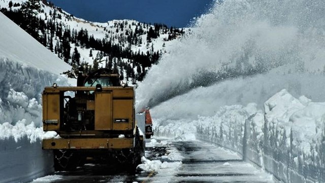A rotary snow plow clears snow from Lassen National Park Highway