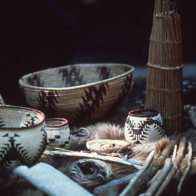 A group of woven baskets on an animal pelt