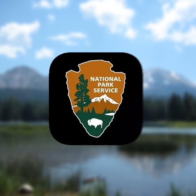 NPS app icon over a blurred image of a mountain and lake