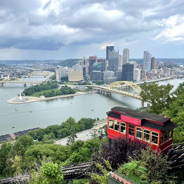  photo from hill with train overlooking a river