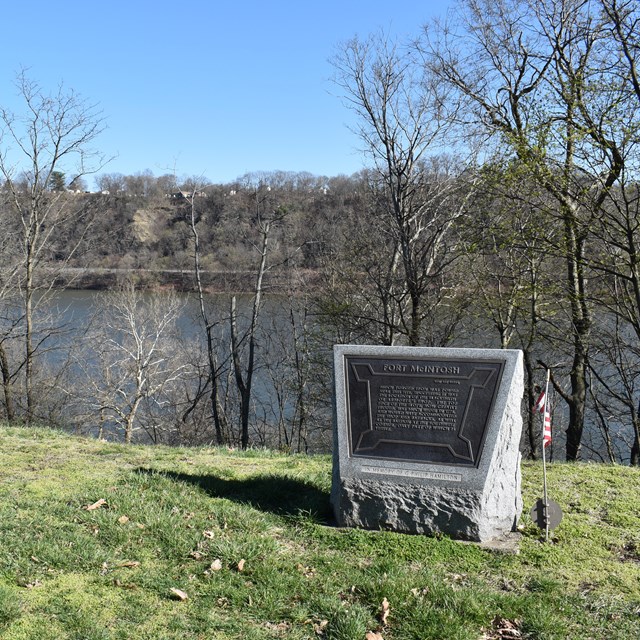  stone sign with river in the background
