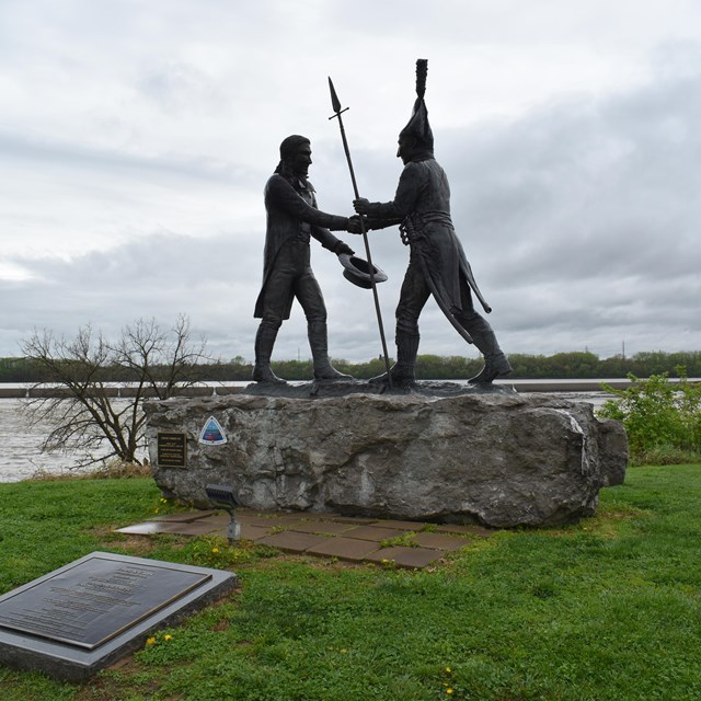 status of two figures shaking hands