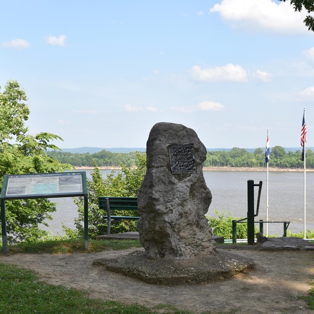 Stone statue overlooking river
