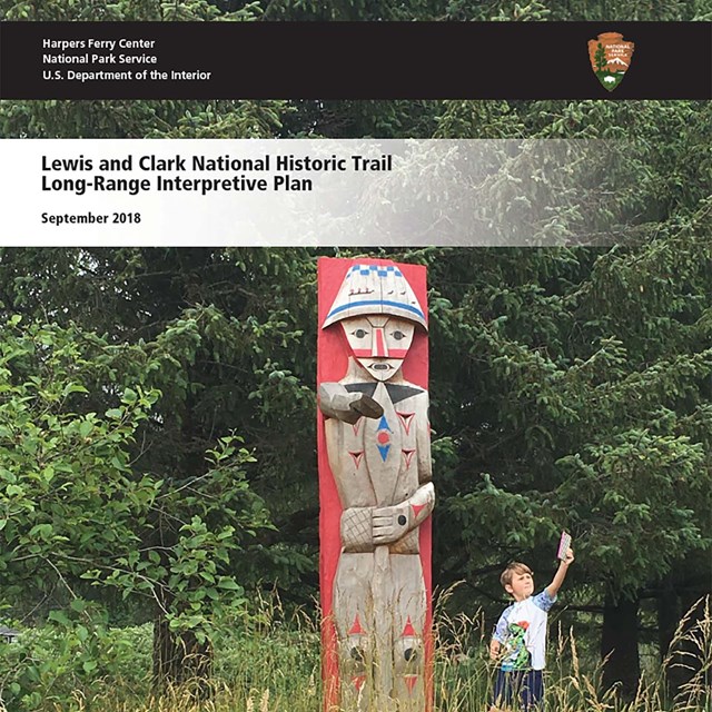 boy taking selfie with totem pole