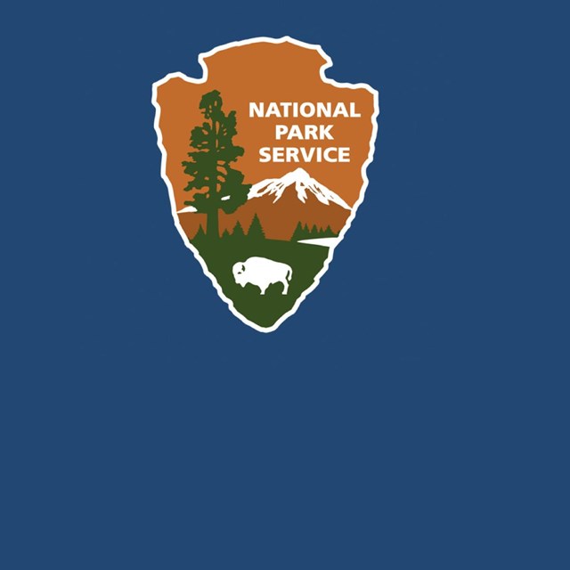 National Park Service Arrowhead logo on blue background